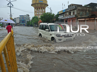 Vehicles are moving through the waterlogged Sikar Road following heavy monsoon rains in Jaipur, Rajasthan, India, on Monday, August 12, 2024...