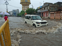 Vehicles are moving through the waterlogged Sikar Road following heavy monsoon rains in Jaipur, Rajasthan, India, on Monday, August 12, 2024...