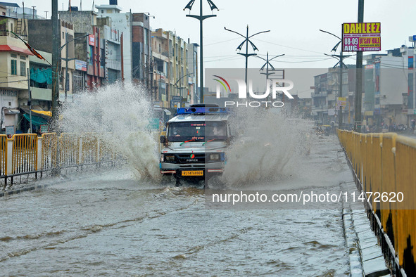 Vehicles are moving through the waterlogged Sikar Road following heavy monsoon rains in Jaipur, Rajasthan, India, on Monday, August 12, 2024...