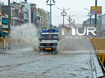 Vehicles are moving through the waterlogged Sikar Road following heavy monsoon rains in Jaipur, Rajasthan, India, on Monday, August 12, 2024...