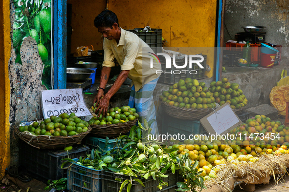 A shopkeeper is filling baskets with limes at a fruit shop at the Chalai market in Thiruvananthapuram (Trivandrum), Kerala, India, on April...