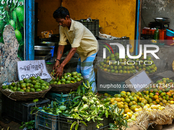 A shopkeeper is filling baskets with limes at a fruit shop at the Chalai market in Thiruvananthapuram (Trivandrum), Kerala, India, on April...