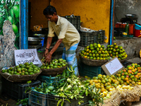 A shopkeeper is filling baskets with limes at a fruit shop at the Chalai market in Thiruvananthapuram (Trivandrum), Kerala, India, on April...