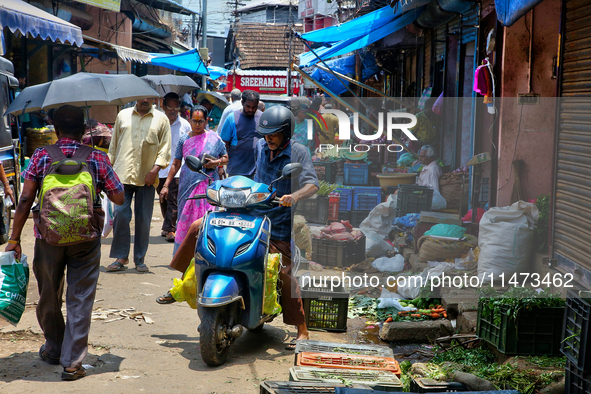 People are purchasing fruits and vegetables at the Chalai market in Thiruvananthapuram, Kerala, India, on April 13, 2024. The Chalai Market...