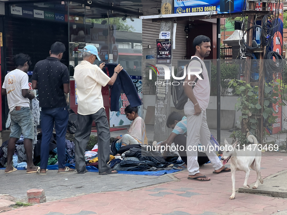 People are purchasing jeans that are being sold along the footpath in Thiruvananthapuram (Trivandrum), Kerala, India, on April 14, 2024. 