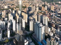 The blue sky and white clouds are silhouetted against urban buildings in Jinan, China, on August 12, 2024. (