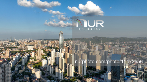 The blue sky and white clouds are silhouetted against urban buildings in Jinan, China, on August 12, 2024. 