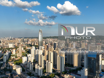 The blue sky and white clouds are silhouetted against urban buildings in Jinan, China, on August 12, 2024. (