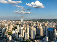 The blue sky and white clouds are silhouetted against urban buildings in Jinan, China, on August 12, 2024. (