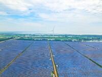 Operation and maintenance personnel are inspecting the operating power generation facilities at the ''fishery-solar hybrid project'' photovo...