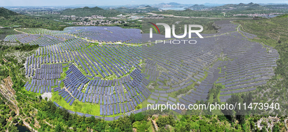 A photovoltaic power station is operating on a barren mountain in Tiankeng village, Shuiquan Town, Zaozhuang Shanting District, Shandong pro...