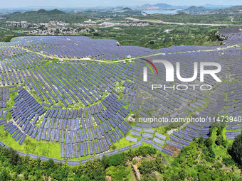 A photovoltaic power station is operating on a barren mountain in Tiankeng village, Shuiquan Town, Zaozhuang Shanting District, Shandong pro...