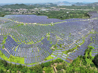 A photovoltaic power station is operating on a barren mountain in Tiankeng village, Shuiquan Town, Zaozhuang Shanting District, Shandong pro...