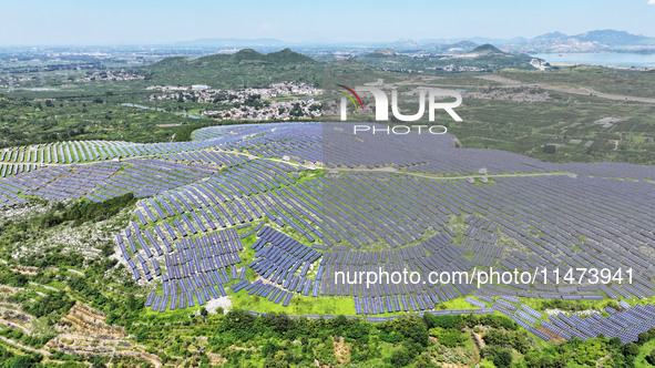 A photovoltaic power station is operating on a barren mountain in Tiankeng village, Shuiquan Town, Zaozhuang Shanting District, Shandong pro...