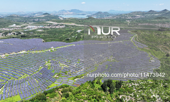 A photovoltaic power station is operating on a barren mountain in Tiankeng village, Shuiquan Town, Zaozhuang Shanting District, Shandong pro...