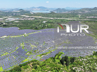 A photovoltaic power station is operating on a barren mountain in Tiankeng village, Shuiquan Town, Zaozhuang Shanting District, Shandong pro...