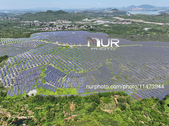 A photovoltaic power station is operating on a barren mountain in Tiankeng village, Shuiquan Town, Zaozhuang Shanting District, Shandong pro...