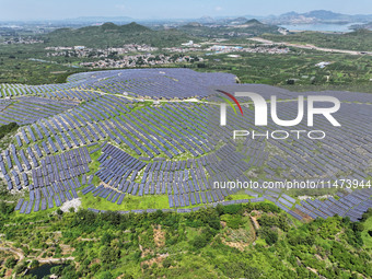 A photovoltaic power station is operating on a barren mountain in Tiankeng village, Shuiquan Town, Zaozhuang Shanting District, Shandong pro...