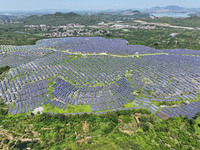 A photovoltaic power station is operating on a barren mountain in Tiankeng village, Shuiquan Town, Zaozhuang Shanting District, Shandong pro...