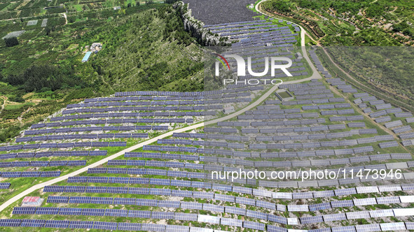 A photovoltaic power station is operating on a barren mountain in Tiankeng village, Shuiquan Town, Zaozhuang Shanting District, Shandong pro...