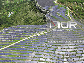 A photovoltaic power station is operating on a barren mountain in Tiankeng village, Shuiquan Town, Zaozhuang Shanting District, Shandong pro...