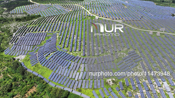 A photovoltaic power station is operating on a barren mountain in Tiankeng village, Shuiquan Town, Zaozhuang Shanting District, Shandong pro...