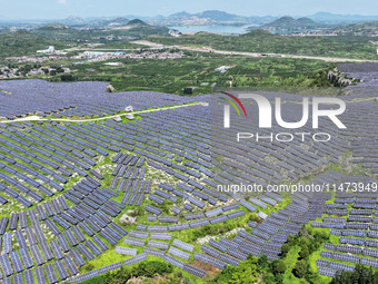 A photovoltaic power station is operating on a barren mountain in Tiankeng village, Shuiquan Town, Zaozhuang Shanting District, Shandong pro...