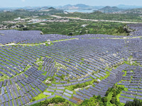 A photovoltaic power station is operating on a barren mountain in Tiankeng village, Shuiquan Town, Zaozhuang Shanting District, Shandong pro...