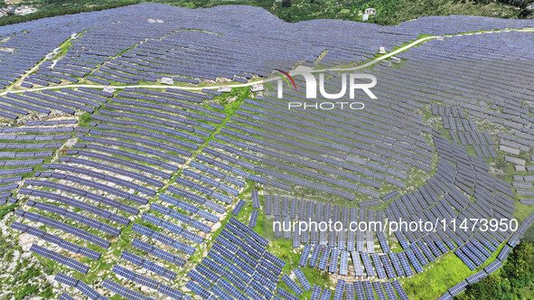 A photovoltaic power station is operating on a barren mountain in Tiankeng village, Shuiquan Town, Zaozhuang Shanting District, Shandong pro...