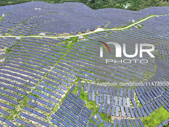 A photovoltaic power station is operating on a barren mountain in Tiankeng village, Shuiquan Town, Zaozhuang Shanting District, Shandong pro...