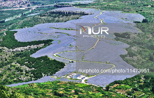 A photovoltaic power station is operating on a barren mountain in Tiankeng village, Shuiquan Town, Zaozhuang Shanting District, Shandong pro...