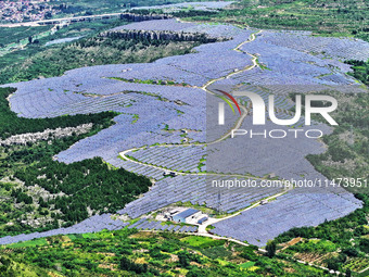 A photovoltaic power station is operating on a barren mountain in Tiankeng village, Shuiquan Town, Zaozhuang Shanting District, Shandong pro...