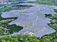 A photovoltaic power station is operating on a barren mountain in Tiankeng village, Shuiquan Town, Zaozhuang Shanting District, Shandong pro...