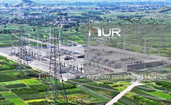 An aerial photo is showing the 1000 kV UHV AC power transmission and transformation project in Zaozhuang, China, on August 12, 2024. The 100...