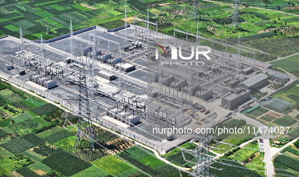 An aerial photo is showing the 1000 kV UHV AC power transmission and transformation project in Zaozhuang, China, on August 12, 2024. The 100...