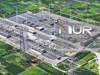 An aerial photo is showing the 1000 kV UHV AC power transmission and transformation project in Zaozhuang, China, on August 12, 2024. The 100...