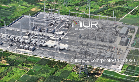 An aerial photo is showing the 1000 kV UHV AC power transmission and transformation project in Zaozhuang, China, on August 12, 2024. The 100...