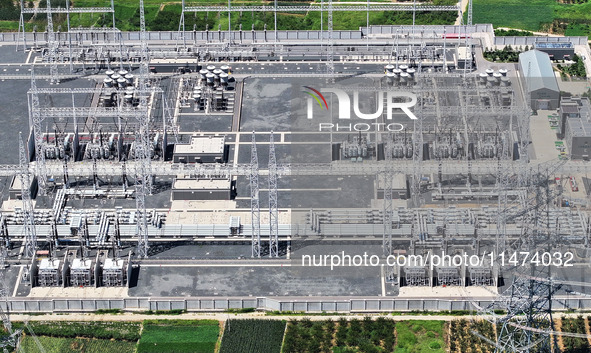 An aerial photo is showing the 1000 kV UHV AC power transmission and transformation project in Zaozhuang, China, on August 12, 2024. The 100...