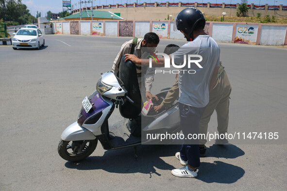 Security personnel are checking a motorist ahead of India's Independence Day celebrations in Srinagar, Jammu and Kashmir, on August 13, 2024...