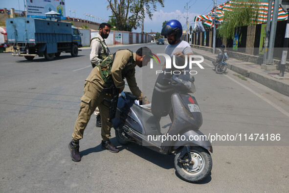 Security personnel are checking a motorist ahead of India's Independence Day celebrations in Srinagar, Jammu and Kashmir, on August 13, 2024...