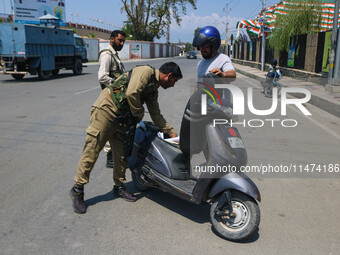 Security personnel are checking a motorist ahead of India's Independence Day celebrations in Srinagar, Jammu and Kashmir, on August 13, 2024...