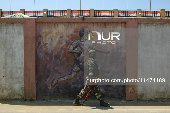 An Indian security personnel is patrolling along a road ahead of India's Independence Day celebrations in Srinagar, Jammu and Kashmir, on Au...