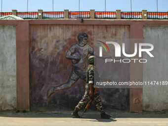 An Indian security personnel is patrolling along a road ahead of India's Independence Day celebrations in Srinagar, Jammu and Kashmir, on Au...