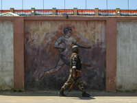 An Indian security personnel is patrolling along a road ahead of India's Independence Day celebrations in Srinagar, Jammu and Kashmir, on Au...