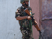 An Indian security personnel is patrolling along a road ahead of India's Independence Day celebrations in Srinagar, Jammu and Kashmir, on Au...