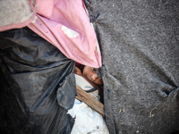 A Palestinian boy is looking outside a tent set on a road's median at a makeshift displacement camp set up along a road in Deir el-Balah in...