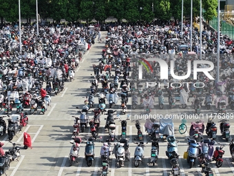 Electric bicycles are being seen at an electric vehicle parking lot near the Suzhou Rail Transit Line 11 Kunshan Huaqiao Station in Suzhou,...