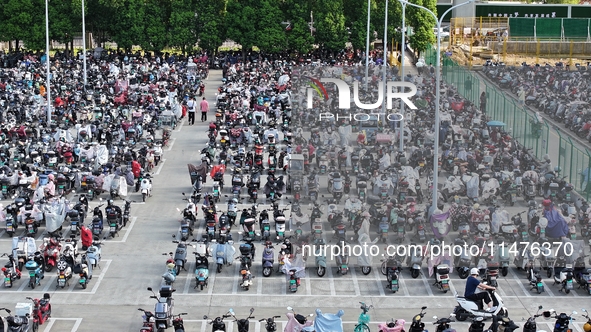 Electric bicycles are being seen at an electric vehicle parking lot near the Suzhou Rail Transit Line 11 Kunshan Huaqiao Station in Suzhou,...