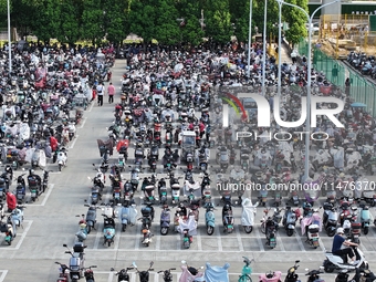 Electric bicycles are being seen at an electric vehicle parking lot near the Suzhou Rail Transit Line 11 Kunshan Huaqiao Station in Suzhou,...