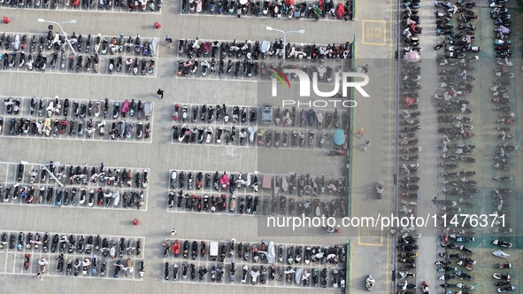 Electric bicycles are being seen at an electric vehicle parking lot near the Suzhou Rail Transit Line 11 Kunshan Huaqiao Station in Suzhou,...